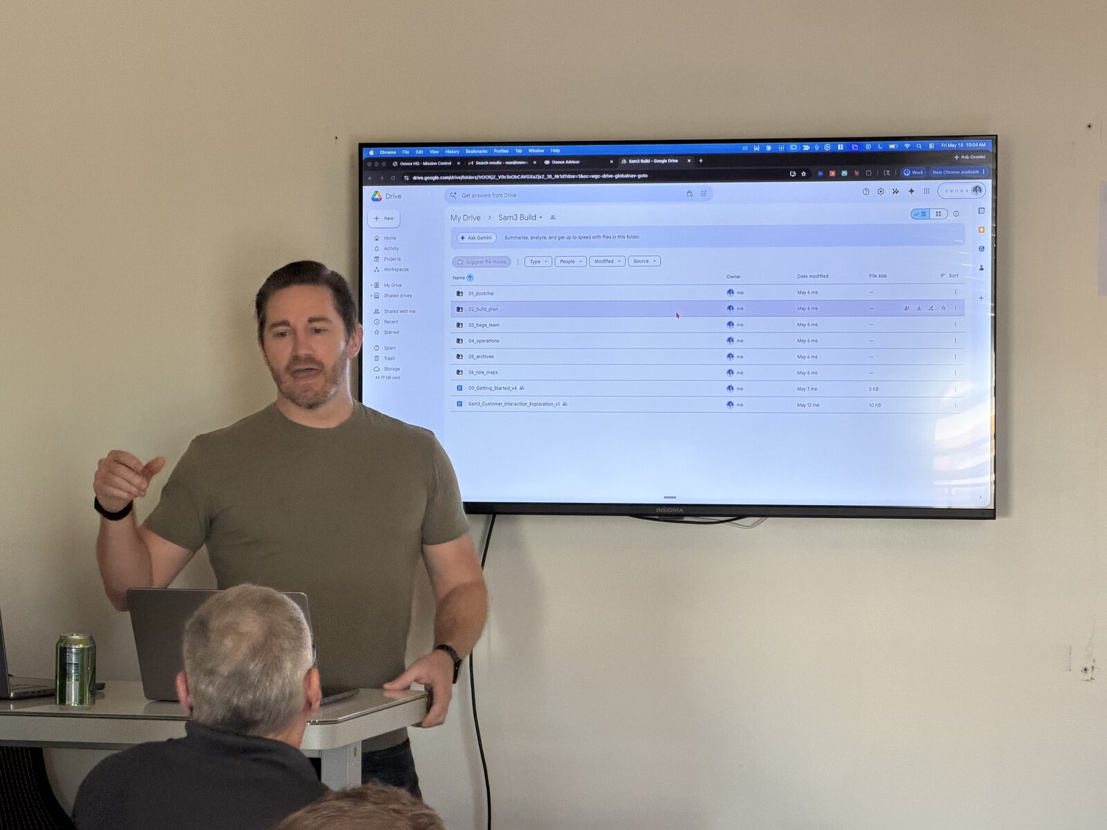 Max presenting beside a screen at AI Friday #3.